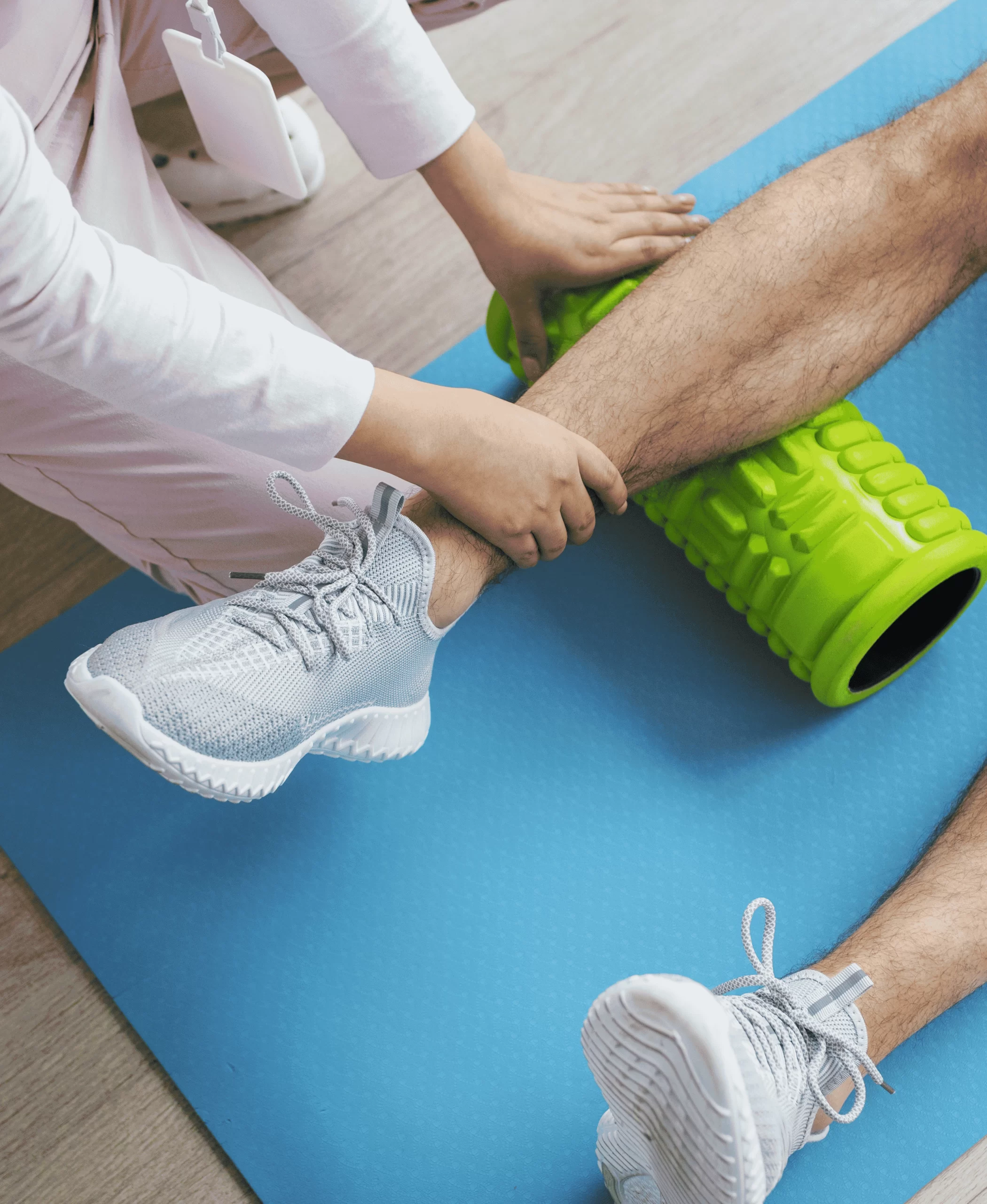 Sports medicine therapist performing muscle therapy on athlete