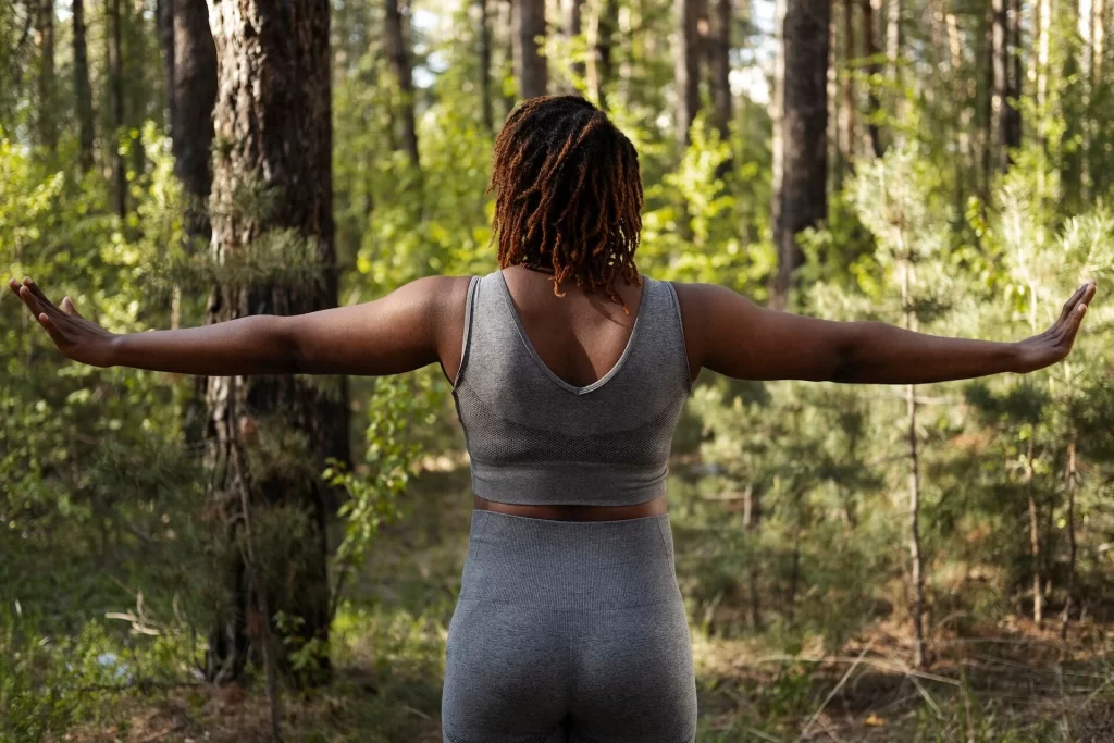 Woman stretching outdoors with text about spine health habits